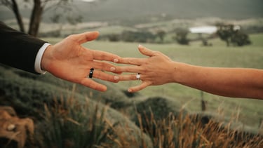 Wedding couple holding hands close up emotional moment outdoor