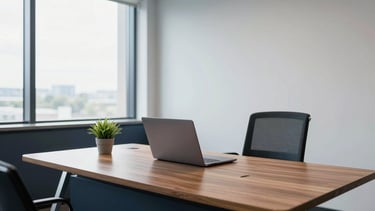 A clean, modern professional workspace in a North American corporate building. A high-end wooden desk with a minimalist laptop and a small green plant. Bright, natural lighting coming from a large window. The scene features dark navy and steel blue accents against pale mist walls. 4k resolution, sharp focus, architectural photography style.