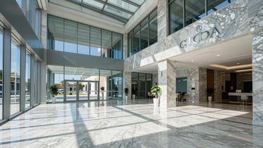 Wide architectural shot of a spotless modern corporate lobby in Córdoba, gleaming marble floors, bright natural daylight through glass walls, cool blue and slate tones