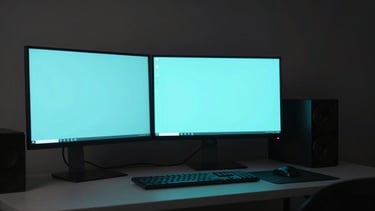 Sleek minimalist desk setup with glowing cyan monitors in low-key ambient lighting, macro depth of field, 35mm