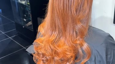 a woman with long red hair and a red hairdoodle