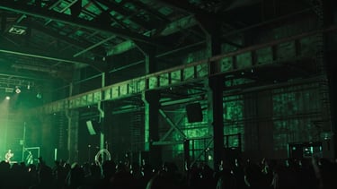 Cinematic music video still, dark industrial warehouse, neon green lighting, dramatic shadows, moody atmosphere