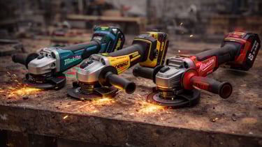 Cordless angle grinders from Makita, DeWalt, and Milwaukee on a metal workshop table with sparks.
