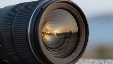 Close-up of a high-quality camera lens reflecting a sunset scene. Sharp focus on the glass elements, blurred background. Turkish / Aegean Coast.