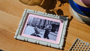     KOIJOY 3D printed frames displayed on a desk in a minimal interior setting