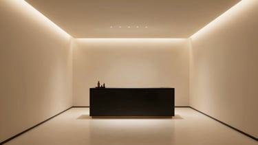 Wide panoramic view of a luxurious minimalist aesthetic clinic interior, warm champagne-gold accents, soft directional lighting, clean lines, serene atmosphere, 21:9 frame