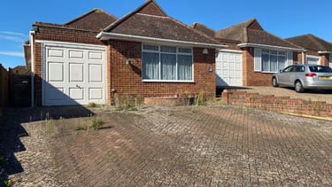 Brick bungalow with attached garage before extension or conversion renovation.