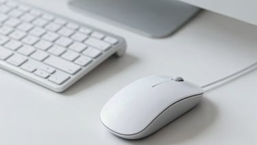 Minimalist desk setup with a designer's mouse and a keyboard. Professional Latin American creative studio environment, colors in ghost white and slate gray blue.