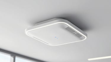 A sleek white enterprise Wi-Fi access point mounted neatly on a modern office ceiling, crisp technical photography, 50mm