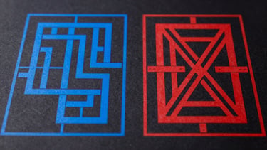 Top-down flat lay of two blueprint-like CAD drawings on a dark background. One drawing shows perfectly clean, closed vector paths in electric blue. The other drawing, next to it, shows overlapping, self-intersecting red vector paths with small gaps, highlighting common errors. High-contrast studio lighting, crisp depth of field.