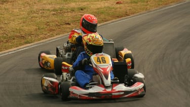 Two people enjoying the fast paced go karting Portugal has to offer