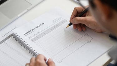 A friendly consultant discussing tax and finance strategies with a small business owner in a modern minimalist workspace.