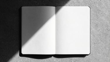 Stark orthographic flat-lay of an empty, unlined open notebook on a raw concrete surface, harsh direct sunlight casting a sharp diagonal shadow across the page, high-contrast monochrome