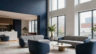A high-end, professional architectural photograph of a modern apartment lobby in a North American city. The scene features minimalist designer furniture in steel blue and soft gray, large windows letting in bright natural light, and clean lines. The atmosphere is sophisticated and quiet, using a palette of dark navy blue and off-white.