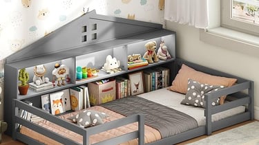 Gray wooden Montessori house bed with a built-in bookshelf headboard for a toddler's bedroom.