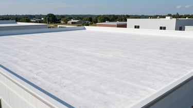 A high-angle professional photograph of a pristine, newly installed white torchdown flat roof on a modern commercial building in Toms River, New Jersey. The scene is bright and clean with a clear blue sky, emphasizing expert construction and durable waterproofing. No people in frame, North American / US architectural style.