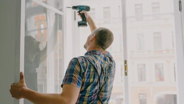 Man drilling on the wall