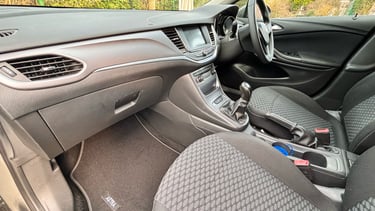 a car dashboard with a steering wheel and a steering wheel