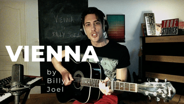 Guitar teacher performing 'Vienna' by Billy Joel in home studio