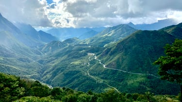 a mountain view of a winding road in the mountains
