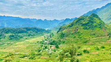 a mountain view of a valley with a road and a road