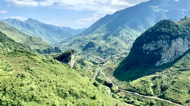 a mountain view of a valley with a winding road