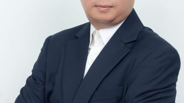 a man in a suit and tie with a red tie