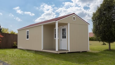 Tan portable cabin shell with front porch - Caney Creek Sheds