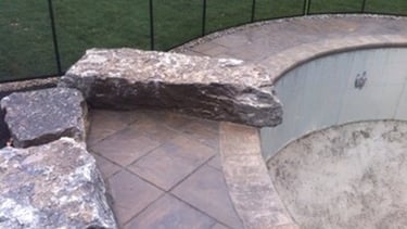 a backyard pool with a swing set and a swing set