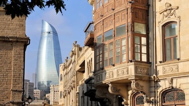 a building with a tall tower in the background