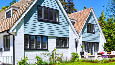 a house with a blue sky and green grass