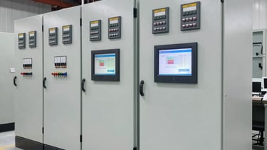 Technician adjusting a sophisticated automation control panel with blue and teal accents