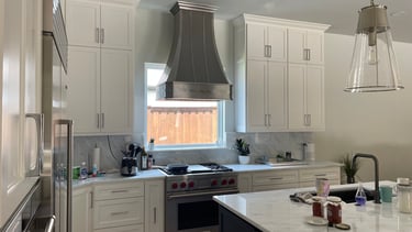 a kitchen with a stove top oven and a stove top