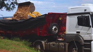 a truck with a large load of sand on it