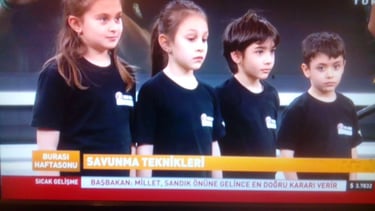 a television screen showing a group of children