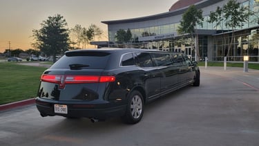 limo parked in front of a building