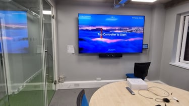 Commercial AV integration featuring a wall-mounted display & professional video conferencing camera