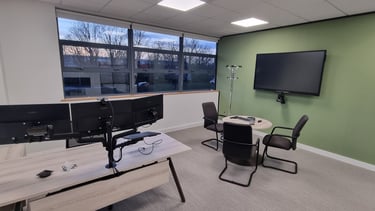 Office AV setup in Milton Keynes: Wall-mounted TV, conference camera, and integrated desk tech.