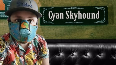 Man in partial pup mask with name plate: Cyan Skyhound