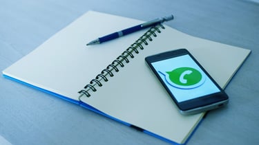 a cell phone and a pen on a notebook