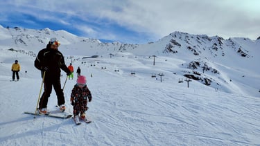a man and a child on skis in the snow