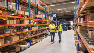 two workers in a warehouse with boxes and boxes