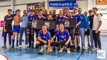 a group of people standing around a table with a plaque