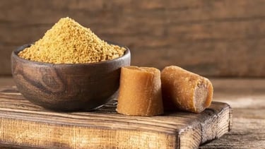 a bowl of jaggery powder with jaggery cubes