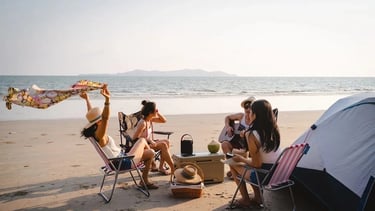 a group of people sitting around a tent
