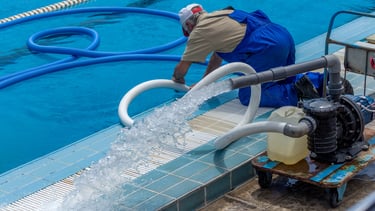 man cleaning pool