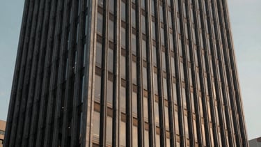 Panoramic architectural crop of a modern corporate building in São Paulo, sharp lines, cinematic evening light.