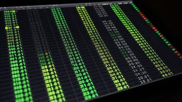 Overhead view of a dark monochrome data grid table displaying virtual football signal rows, with neon green accent highlights on active signal entries, numerical cycle positions and lag counters visible in each column, studio precision lighting, high contrast on near-black background, no human figures
