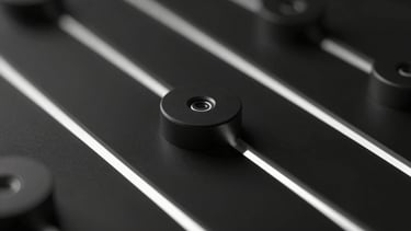 Macro close-up of dark metallic hardware nodes, subtle white digital luminescence, high-contrast low-key lighting, minimalist abstract geometry