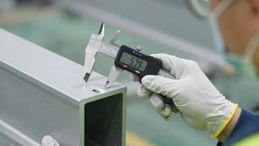 Construction workers collaborating on a building site with blueprints.